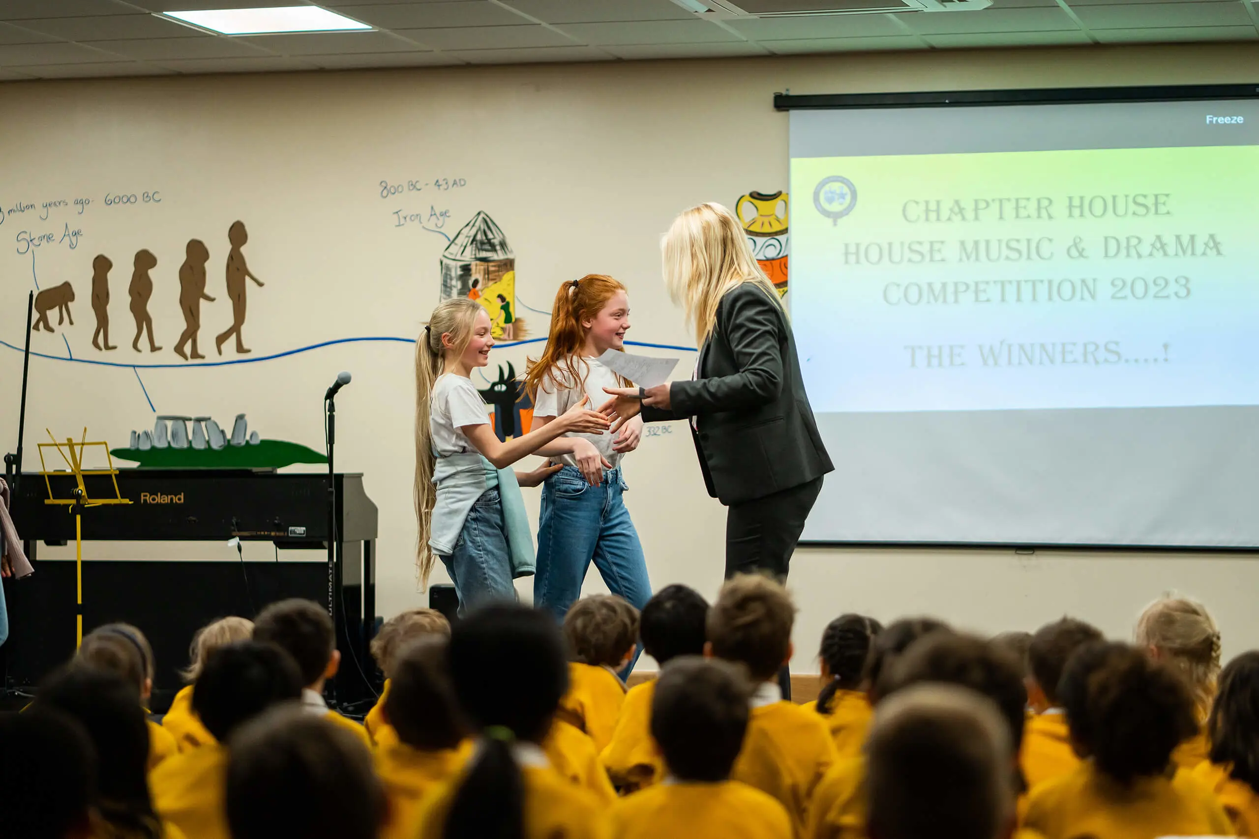 Two girls winning the Music and Drama House Competition at Chapter House