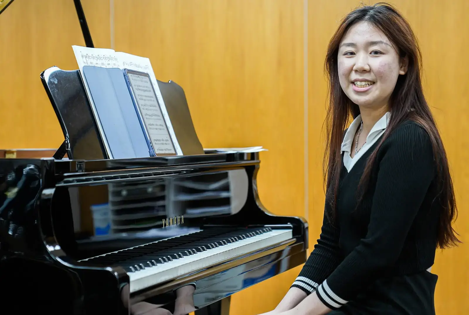 QE College student playing piano