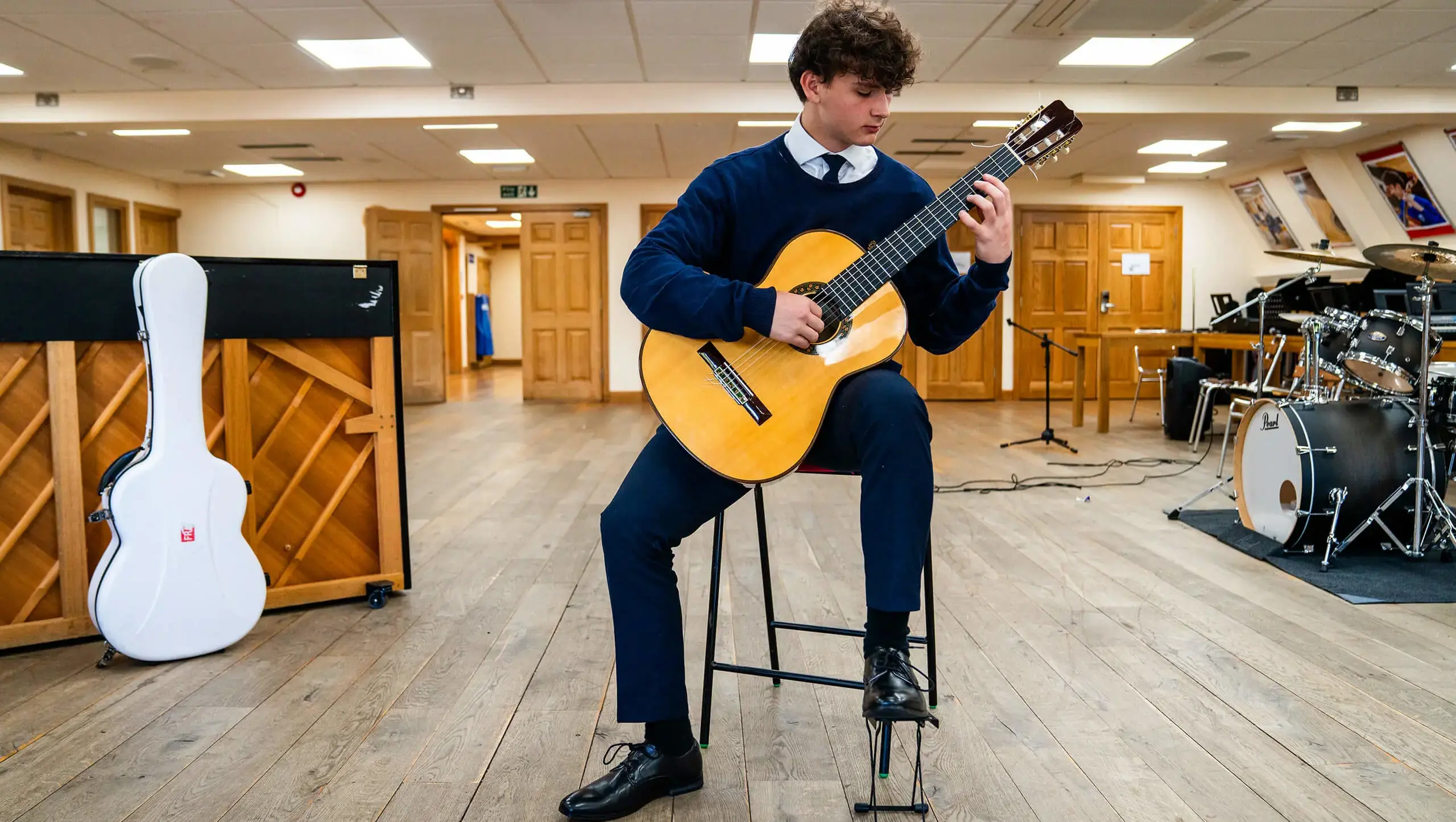 QE College student playing guitar