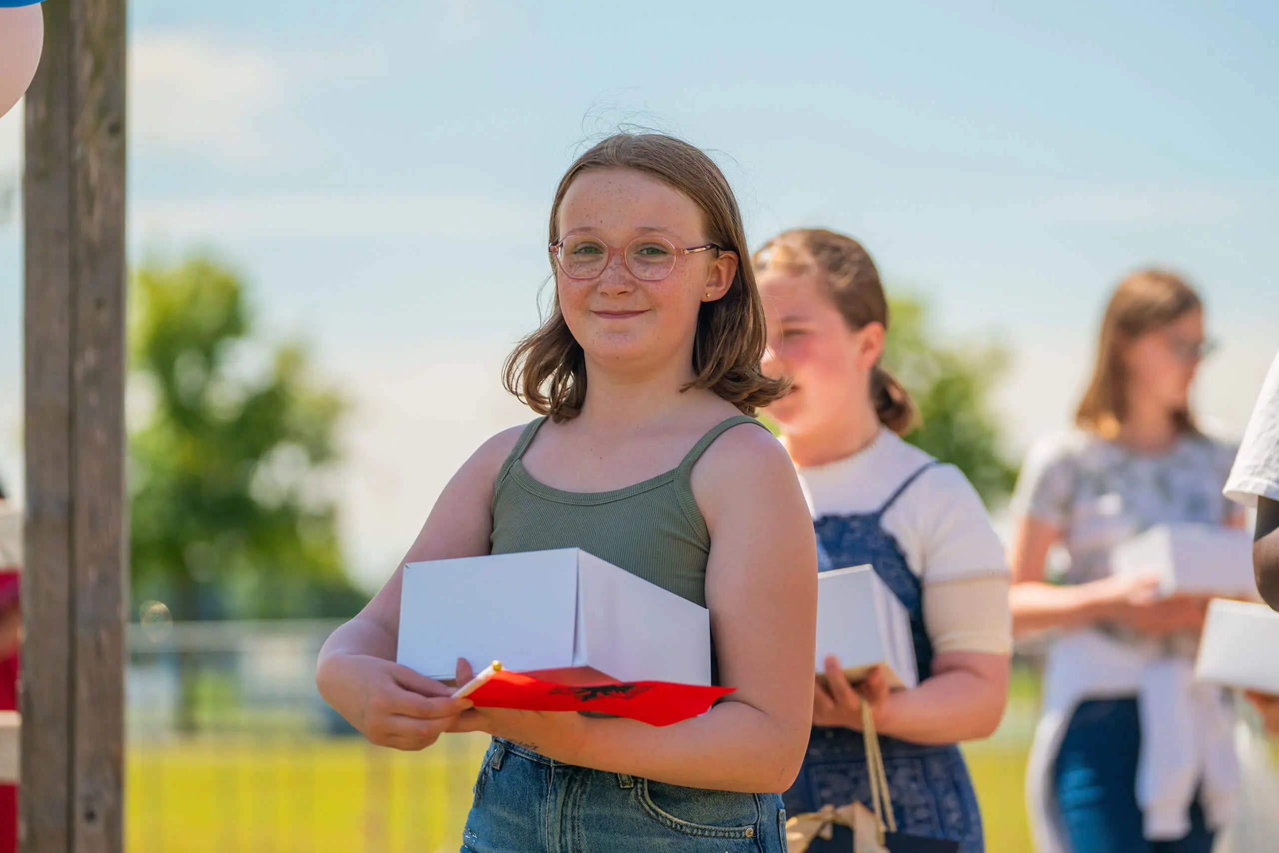 Student holding a picnic box on the last day of school.