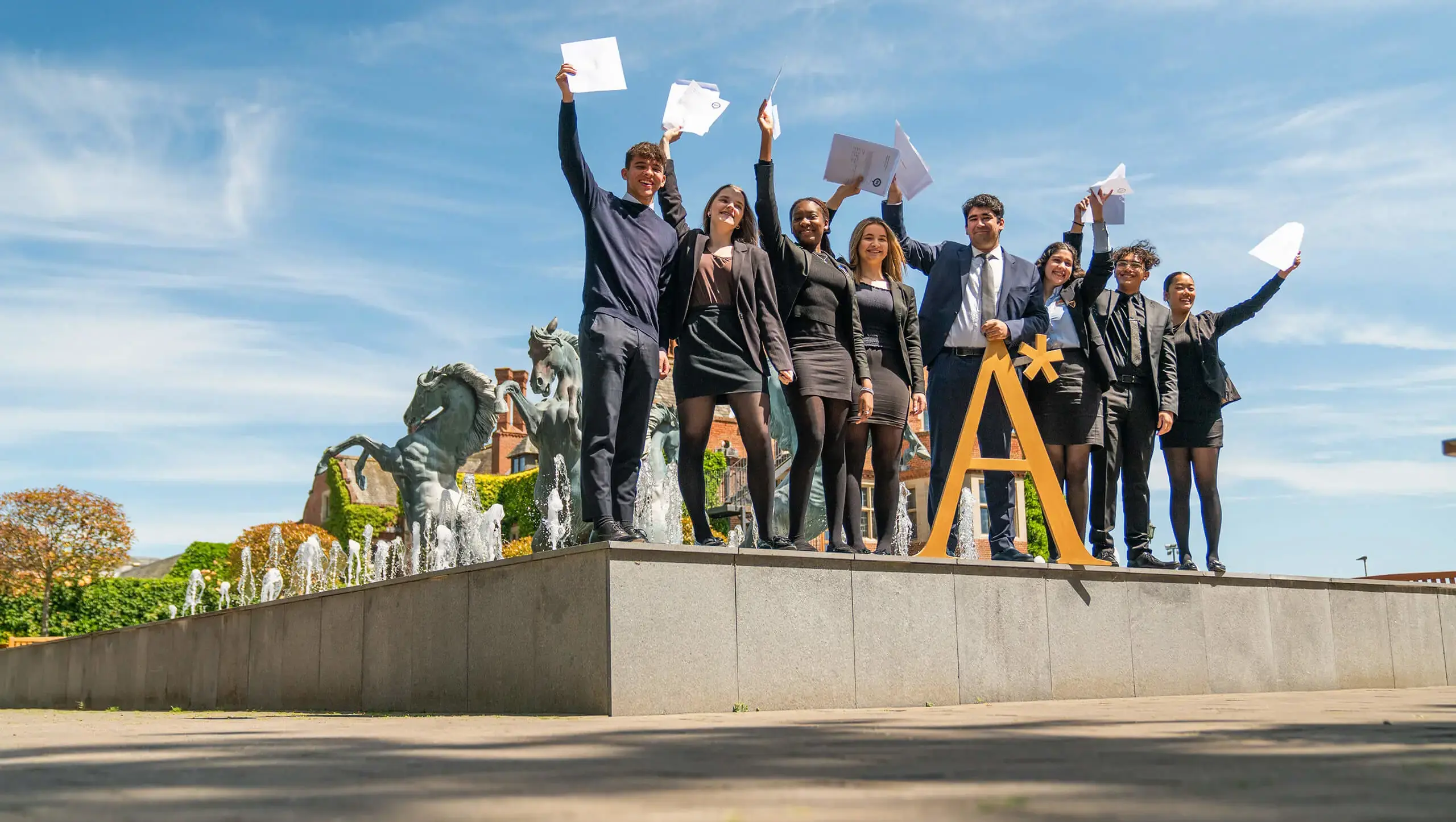 QE College students celebrating their exam results