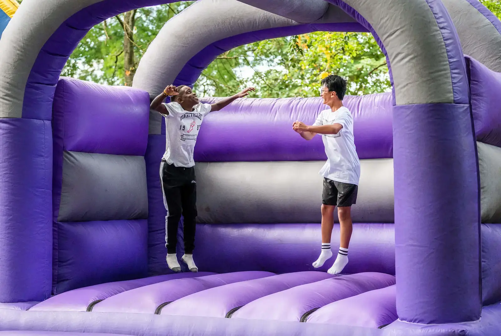 Queen Ethelburga's Boarding pupils having fun on a bouncy castle