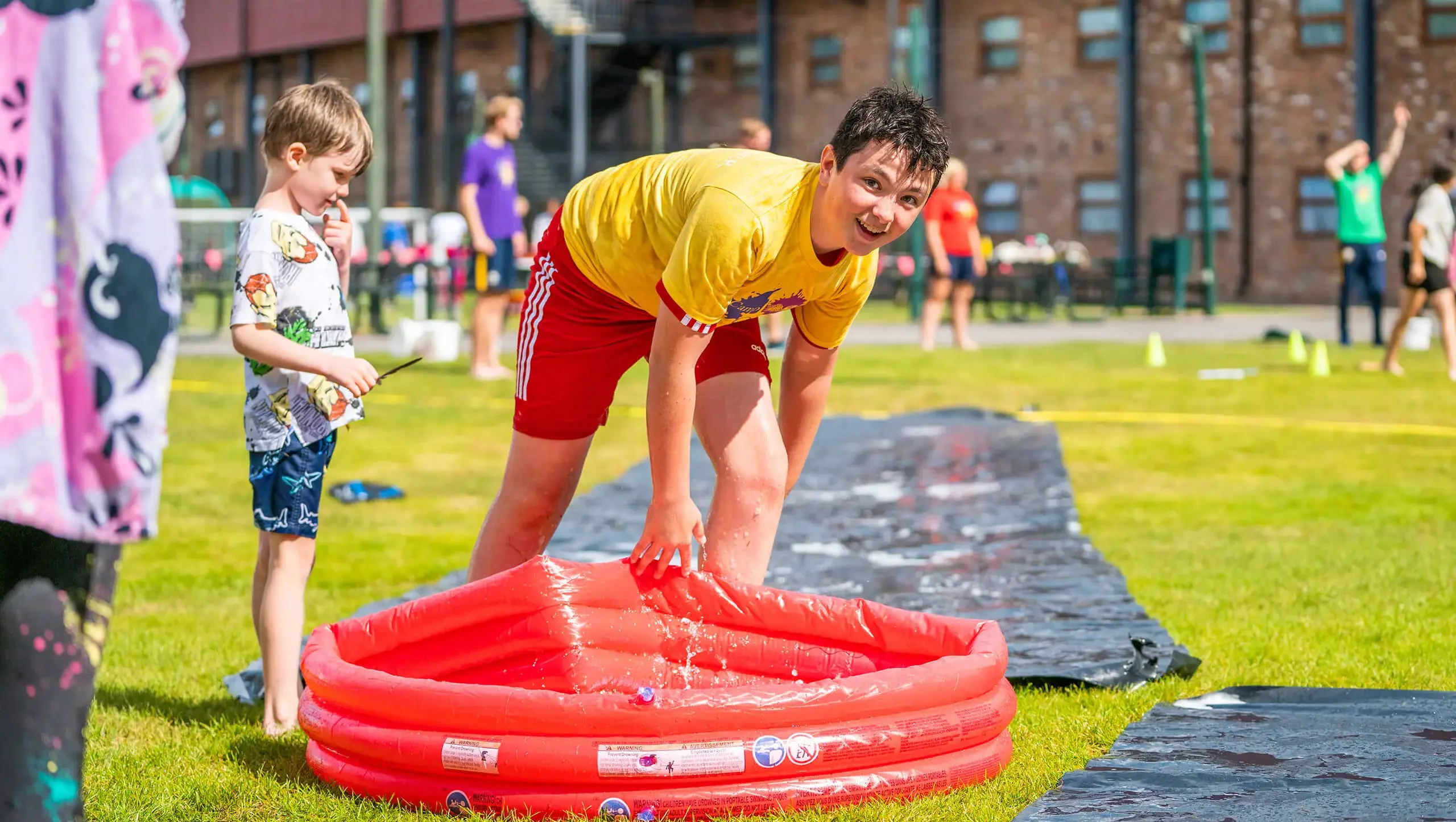 Child enjoying a water slide at summer camp