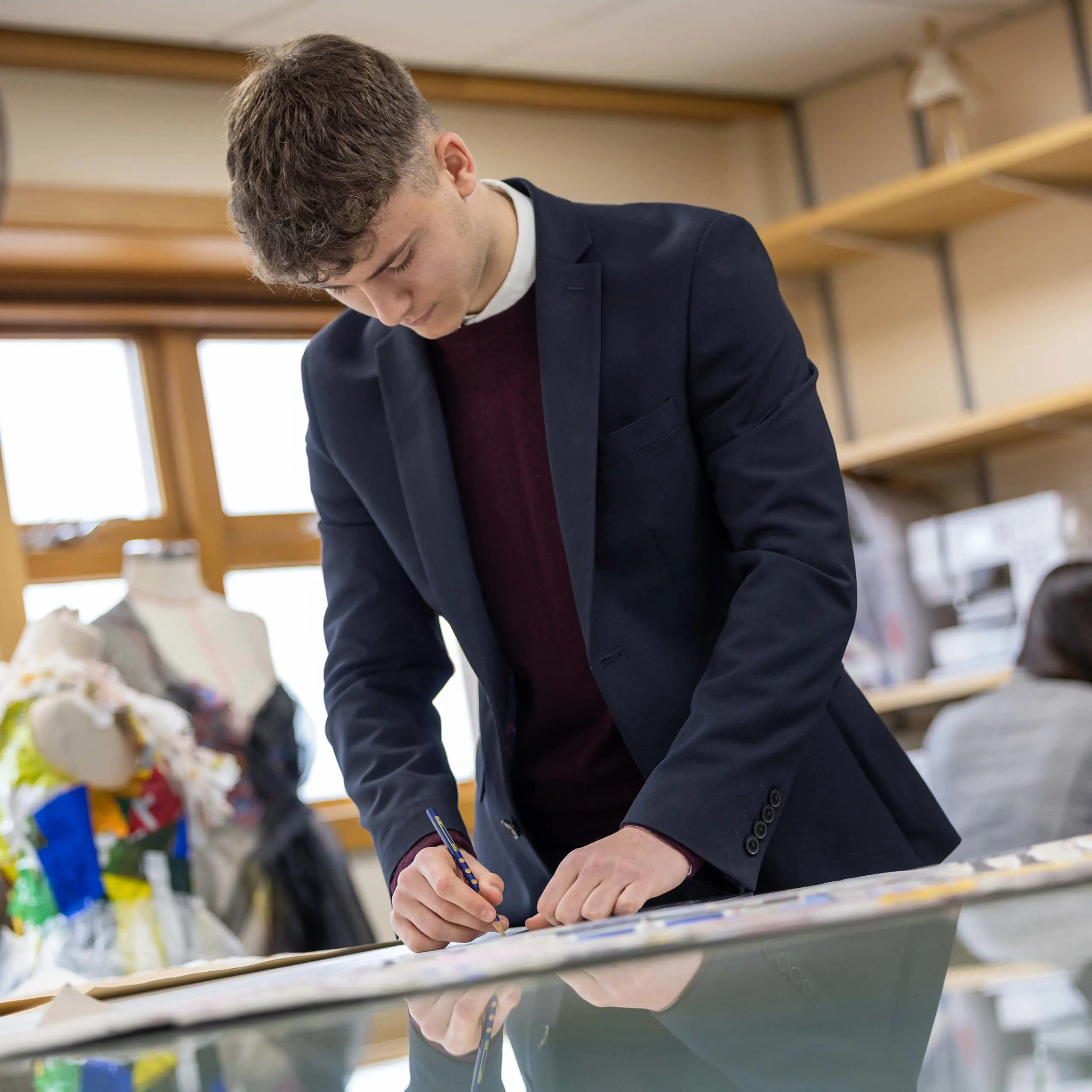 Student at QE College working in art class