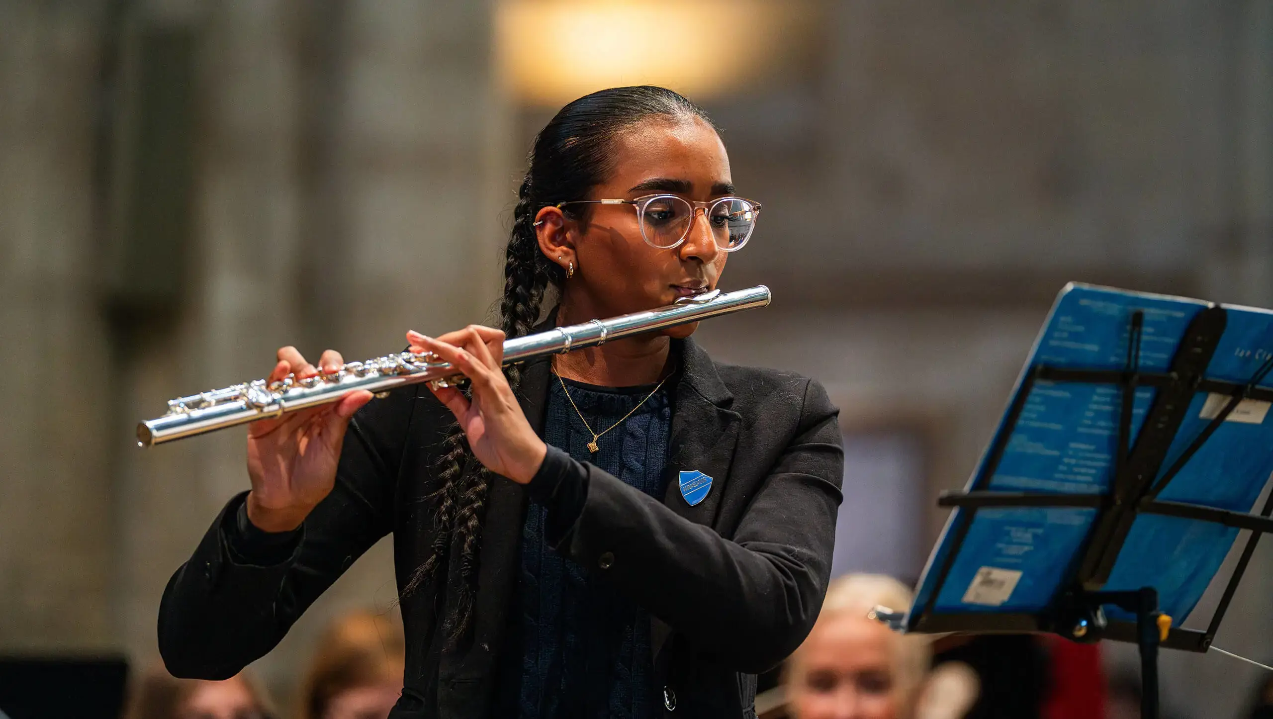 Student playing the flute at the carol service at top music school.