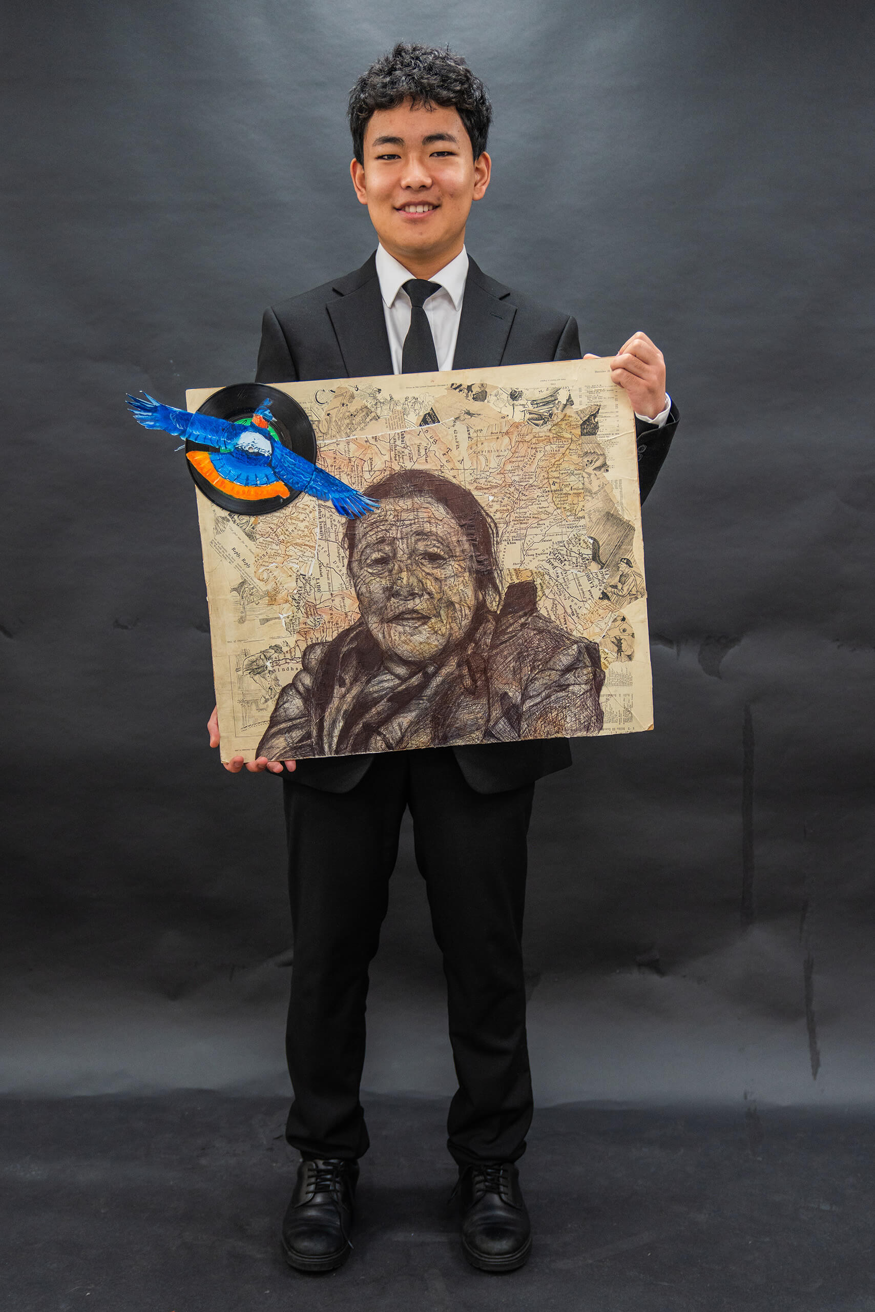 One of the winning students holding their artwork.