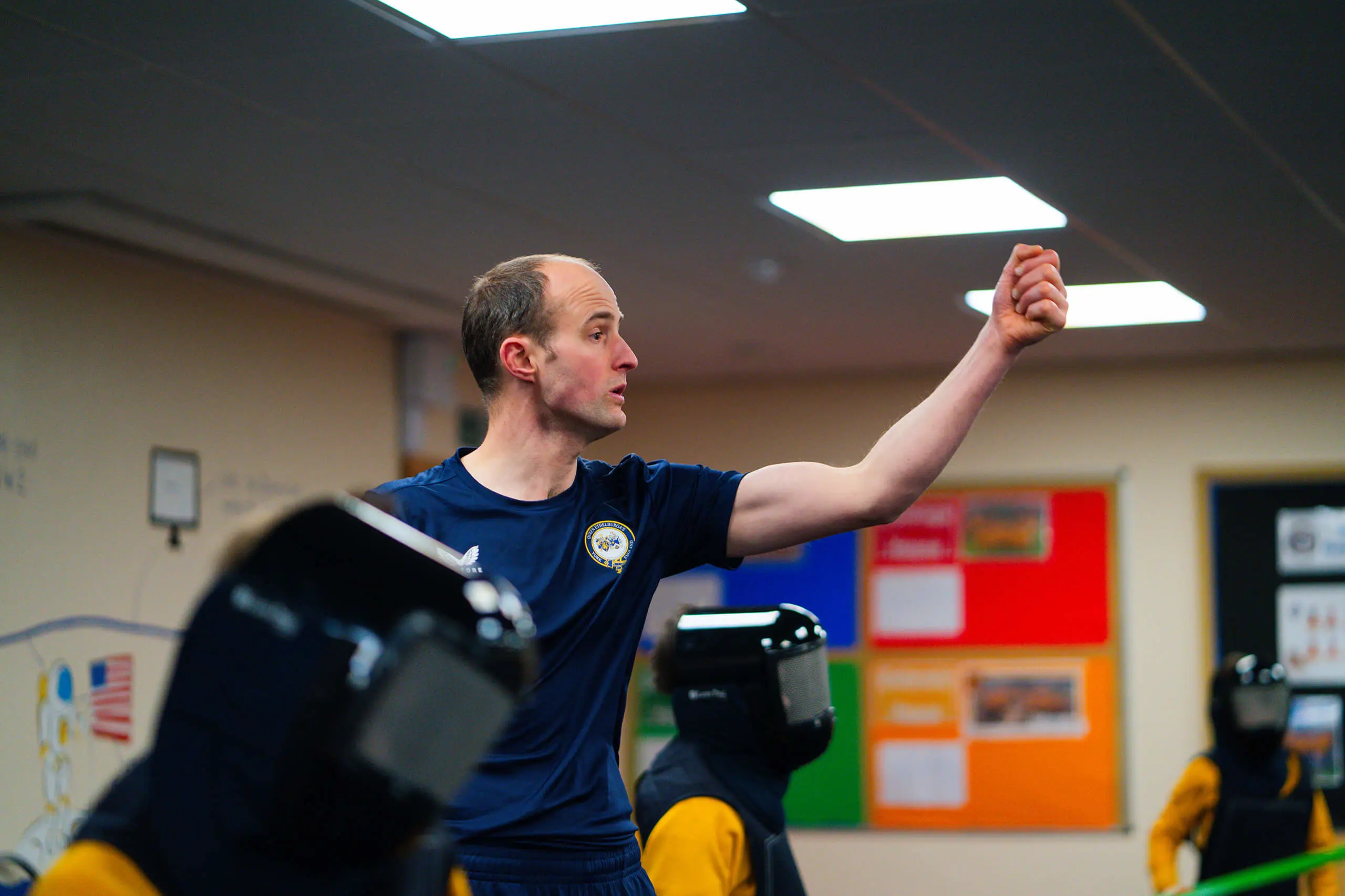 Ed Mason teaching a fencing lesson.