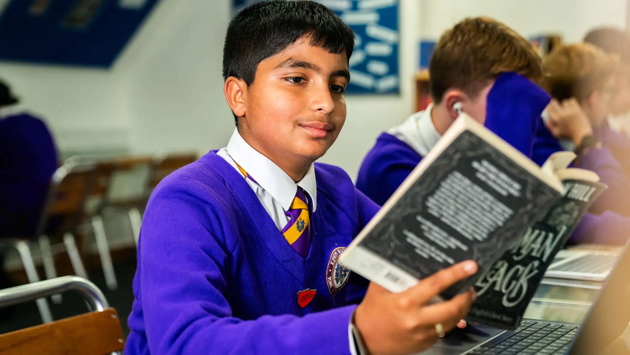 A King's Magna Middle School pupil reading a book in class