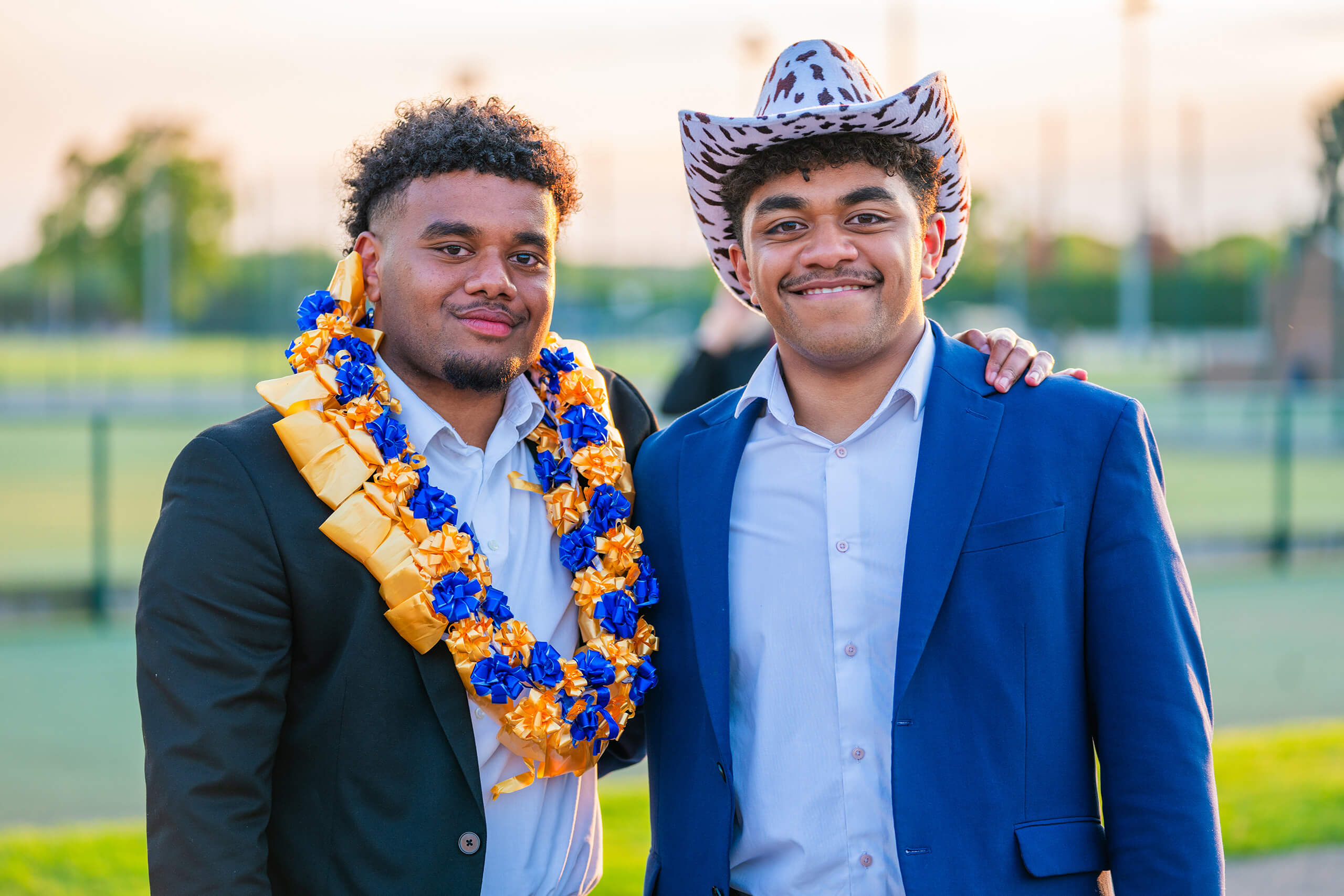 Two Faculty students celebrating their graduation service,