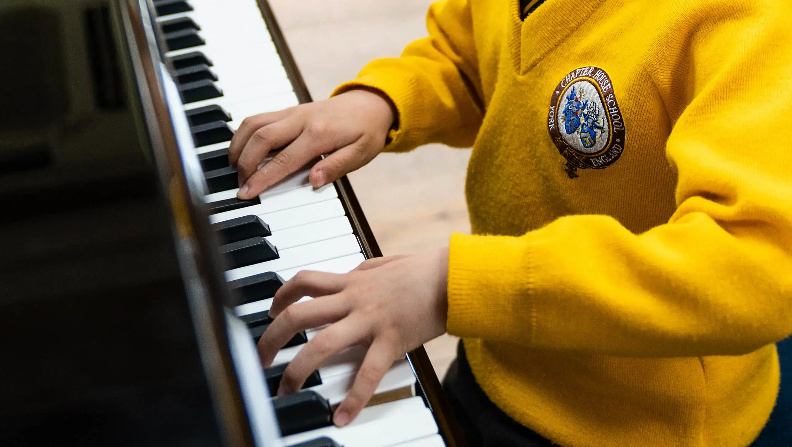 Pupil playing piano at Chapter House