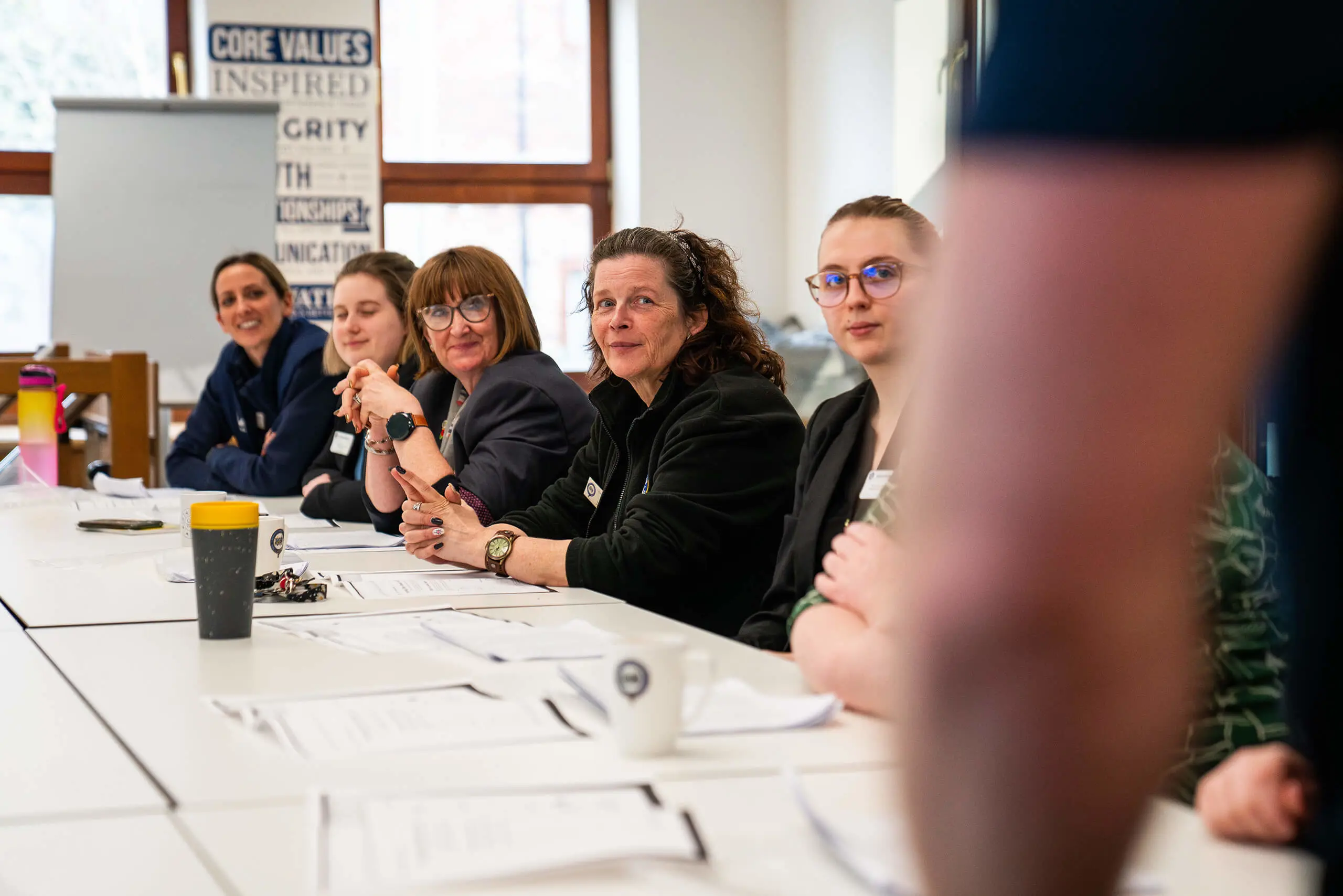 Teachers, house keepers and staff learning sign language at QE Training Academy