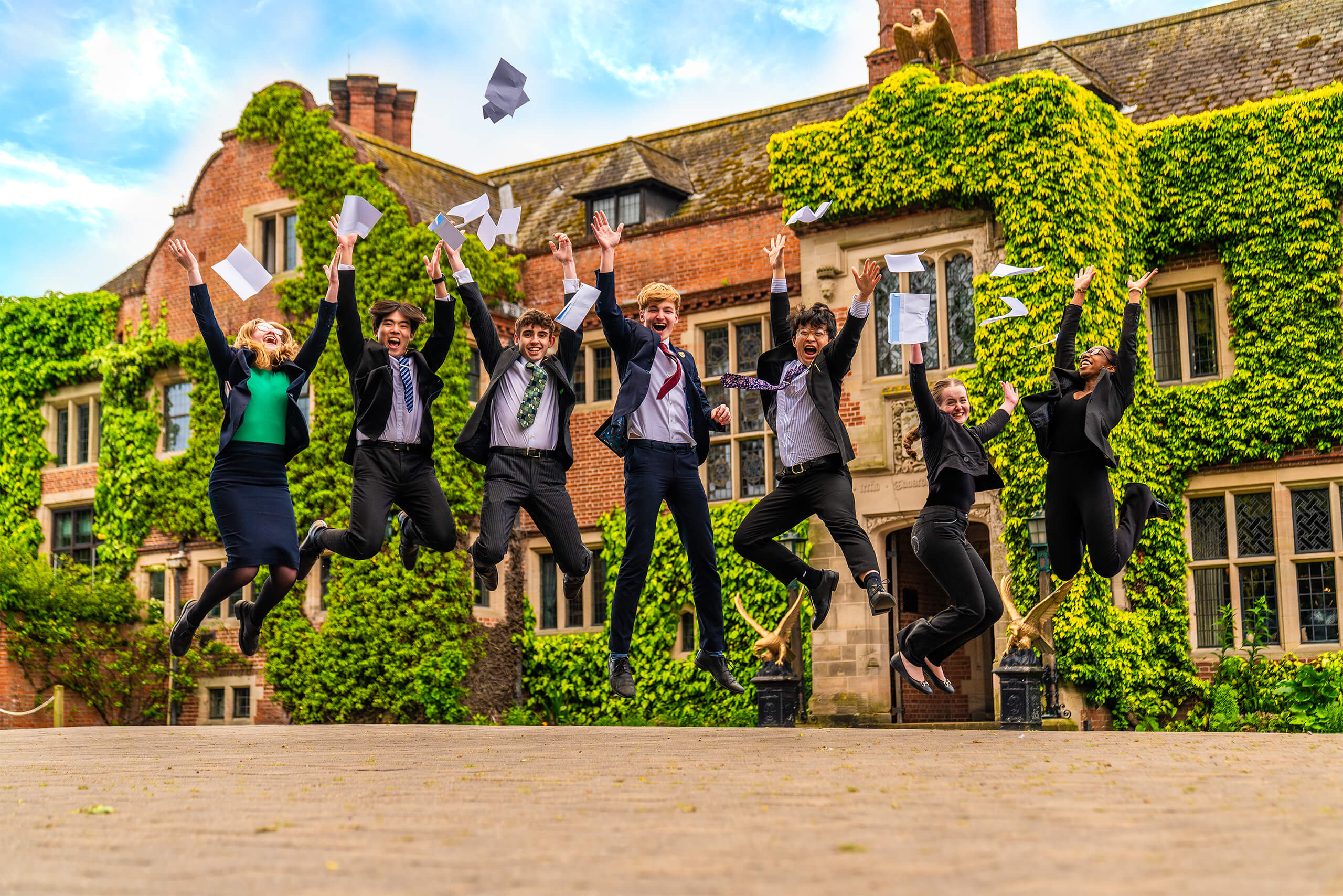 Students jumping for joy at their A Level results.