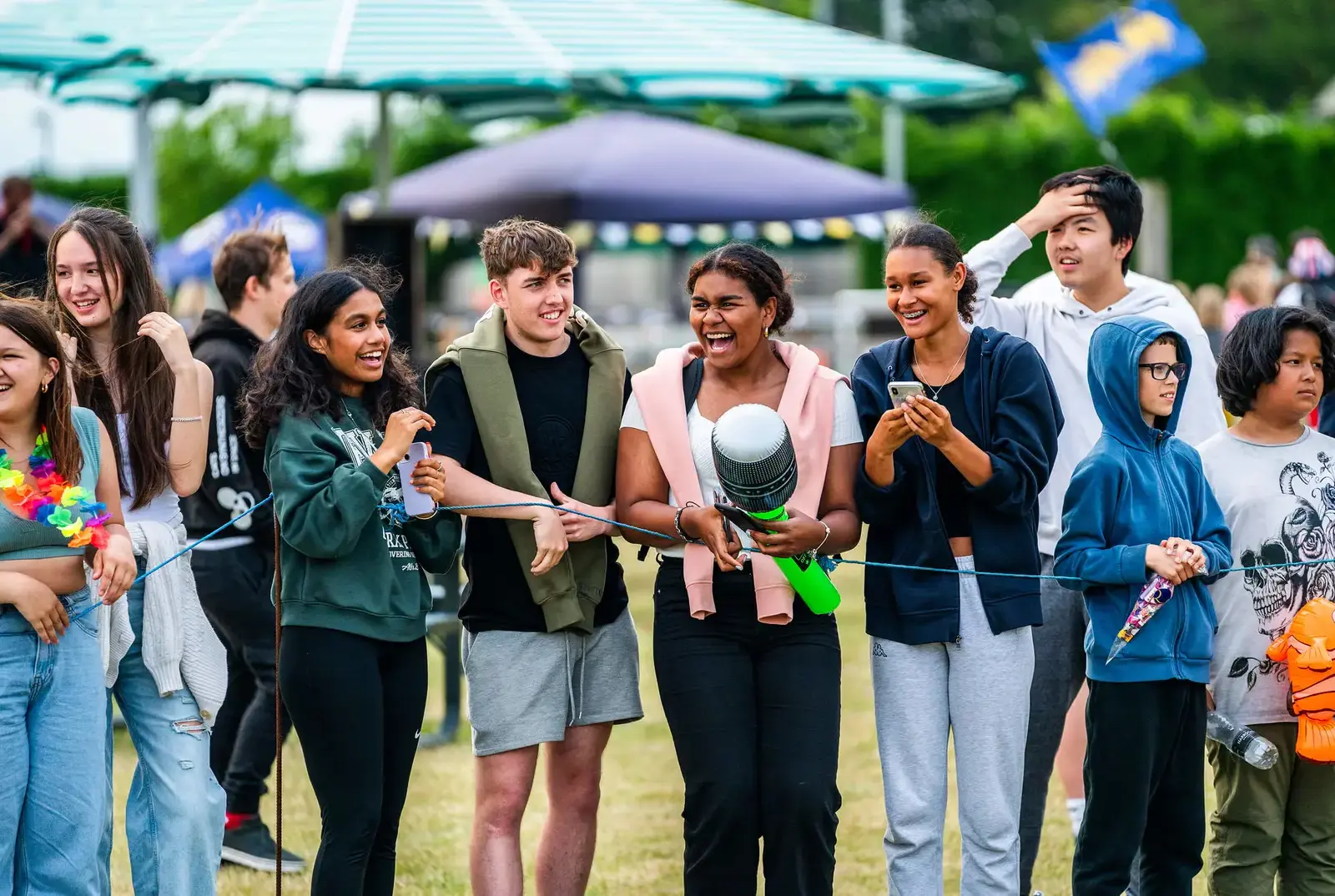 Students smiling at the end of year celebration.