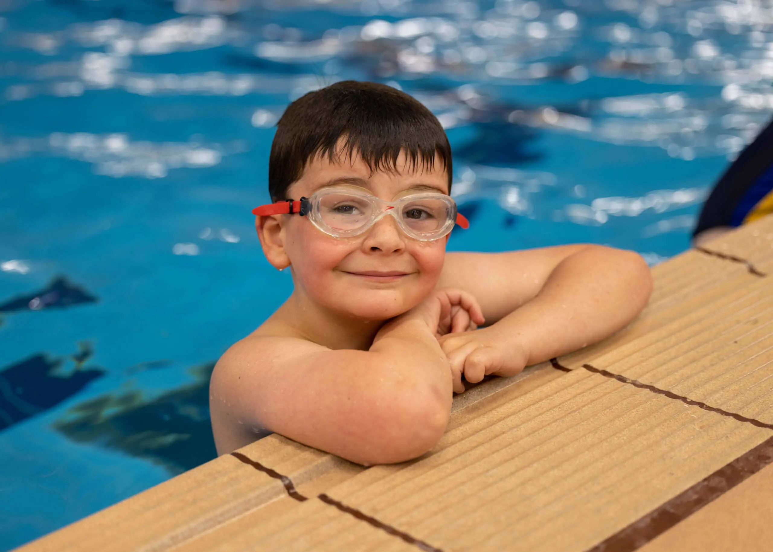 Chapter House boy smiling in the pool.