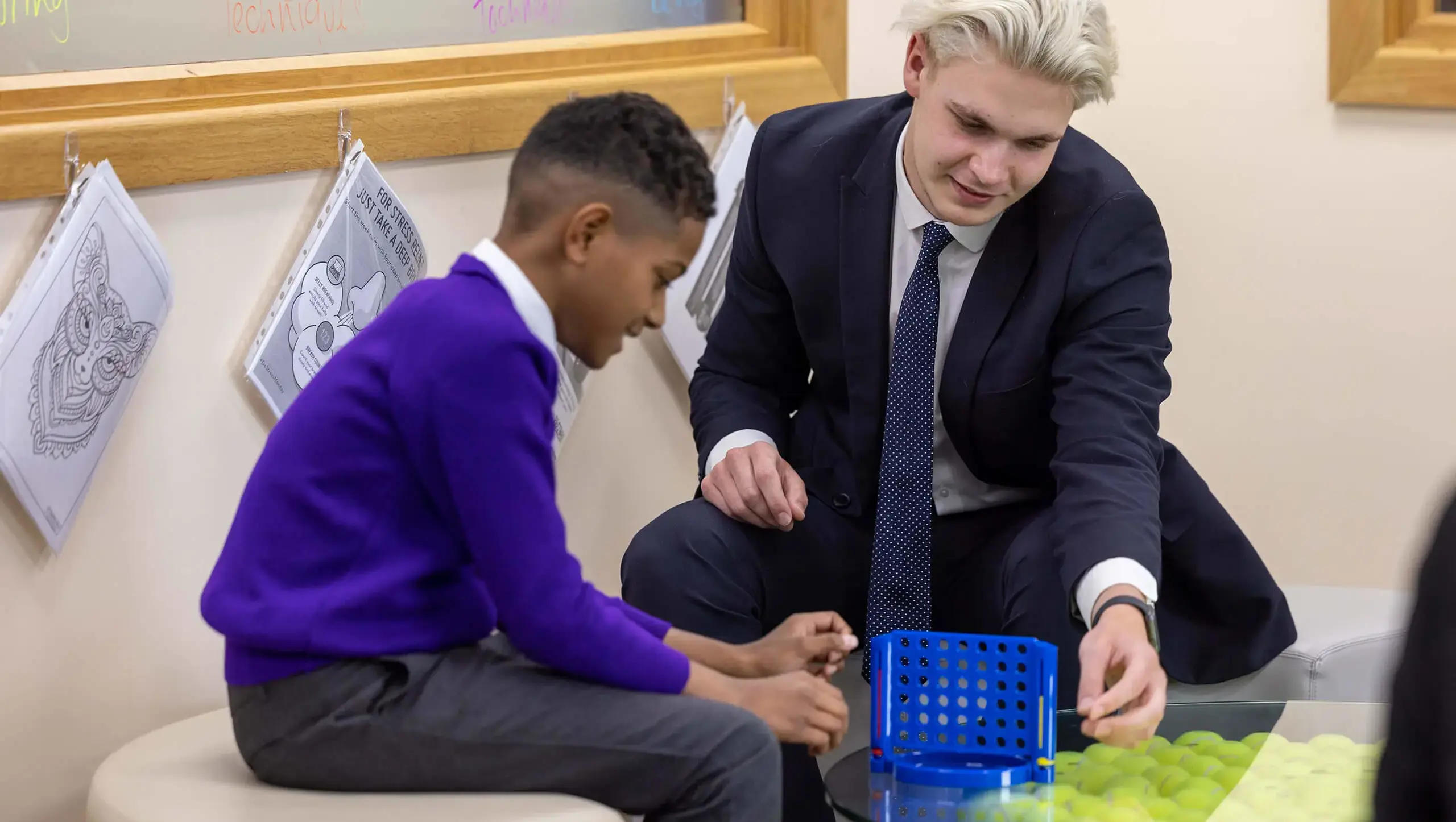 Queen Ethelburga's Senior school pupil working with a younger pupil